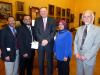 Justice Dennis G. Eveleigh, center, with members of the Muslim Coalition