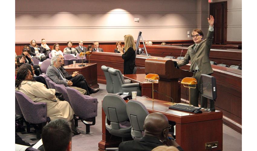 Yale Professor Dan M. Kahan speaks while an interpreter signs the lecture.