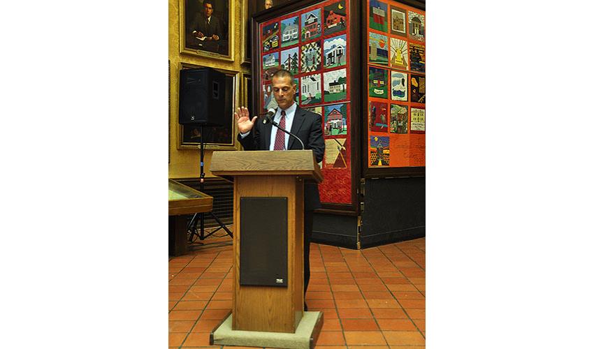 Paul S. Hartan, acting chief clerk of the appellate system, administers the oath of Commissioner of Superior Court. 