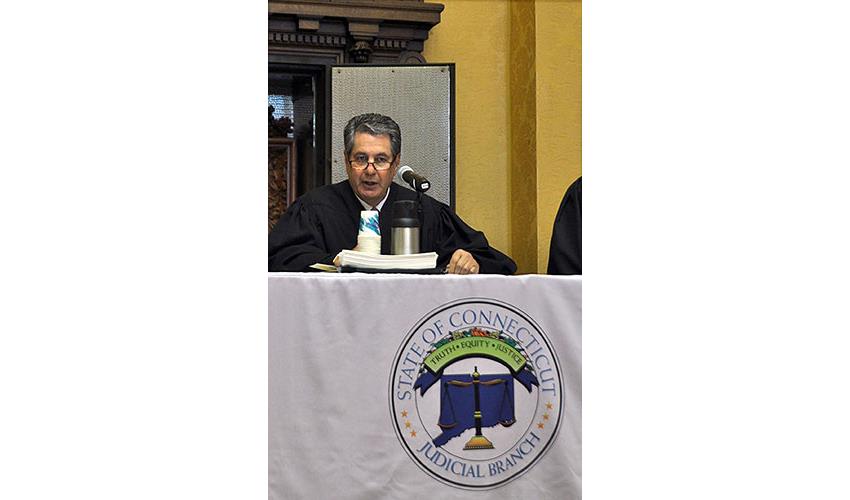 Justice Richard N. Palmer presides over the afternoon swearing in ceremony.