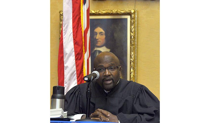 Justice Richard A. Robinson addresses the candidates just before their swearing in.