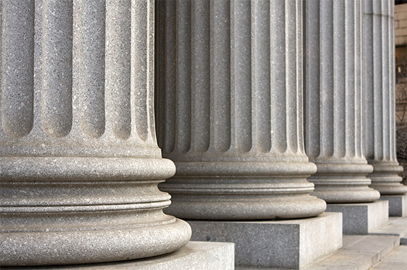 Photo of the base of stone columns in front of the courthouse