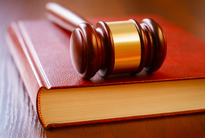 Photo of a judge's gavel on leather bound book