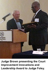 Judge Brown presenting the Court Improvement Innovations and Leadership Award to Judge Foley.